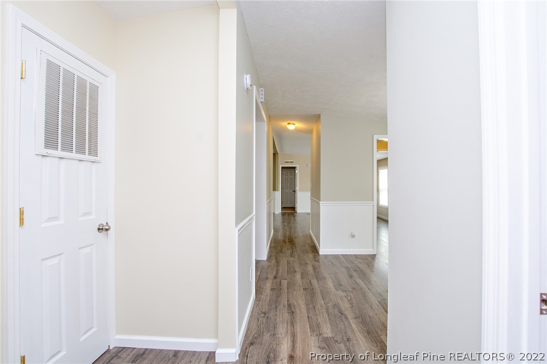 246 Loop Road Raeford, NC 28376 - Photo 23 of 42 a view of a hallway with wooden floor