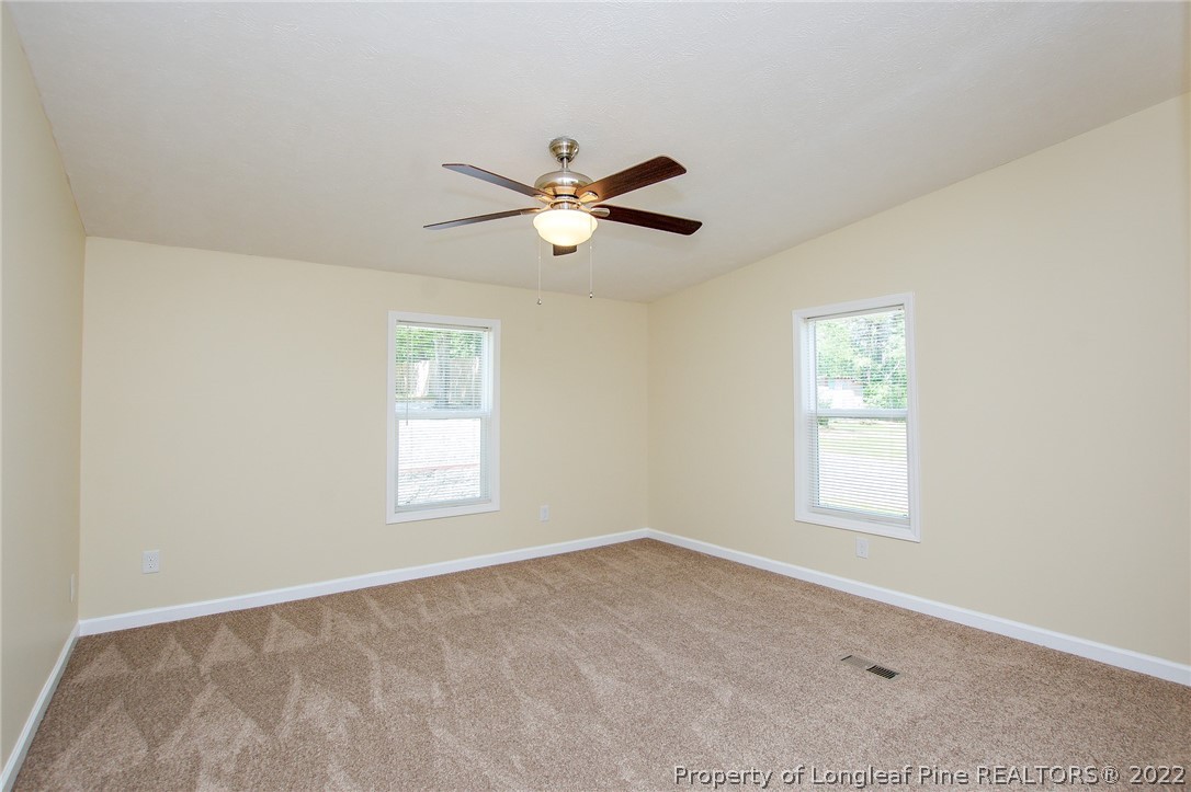 246 Loop Road Raeford, NC 28376 - Photo 28 of 42 a view of a room with windows and ceiling fan