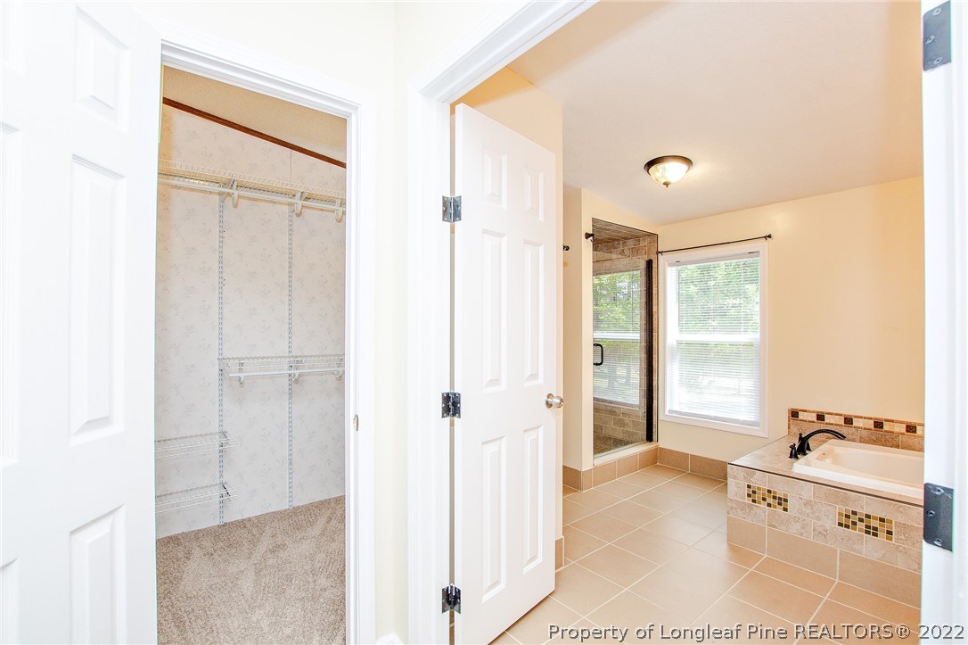 246 Loop Road Raeford, NC 28376 - Photo 30 of 42 a bathroom with a tub shower and a sink