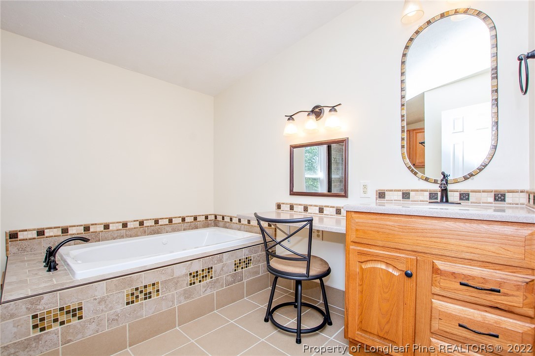 246 Loop Road Raeford, NC 28376 - Photo 31 of 42 a view of a bathroom sink and mirror