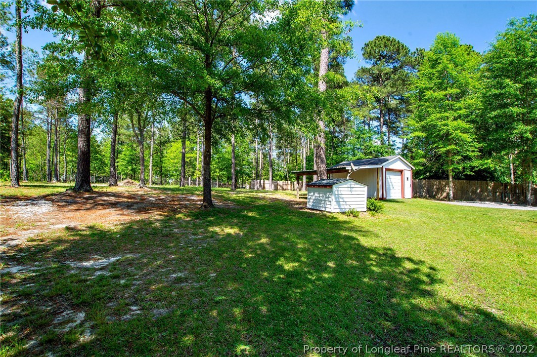 246 Loop Road Raeford, NC 28376 - Photo 40 of 42 a front view of a house with garden