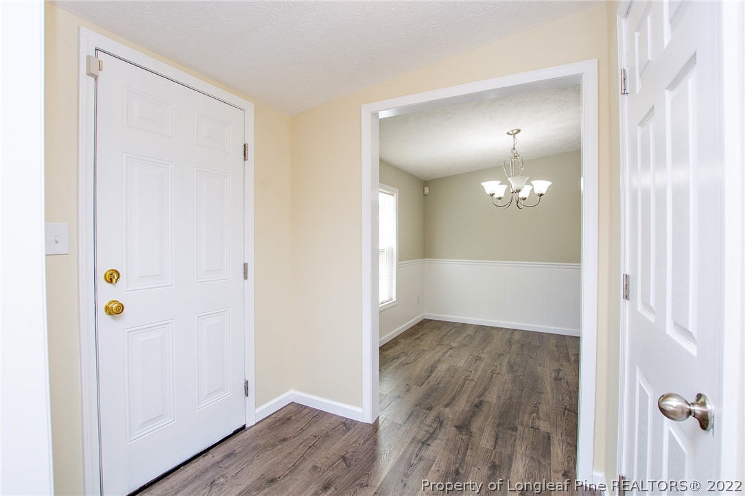 246 Loop Road Raeford, NC 28376 - Photo 7 of 42 a view of a hallway with wooden floor