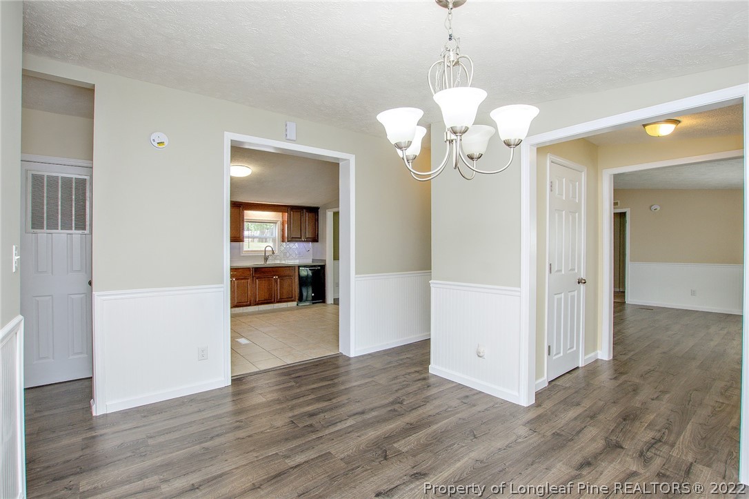 246 Loop Road Raeford, NC 28376 - Photo 8 of 42 a view of an empty room with wooden floor