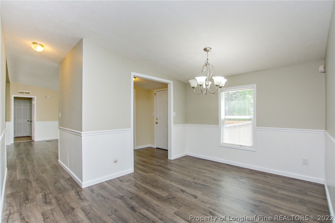 246 Loop Road Raeford, NC 28376 - Photo 9 of 42 a view of an empty room with wooden floor and a window