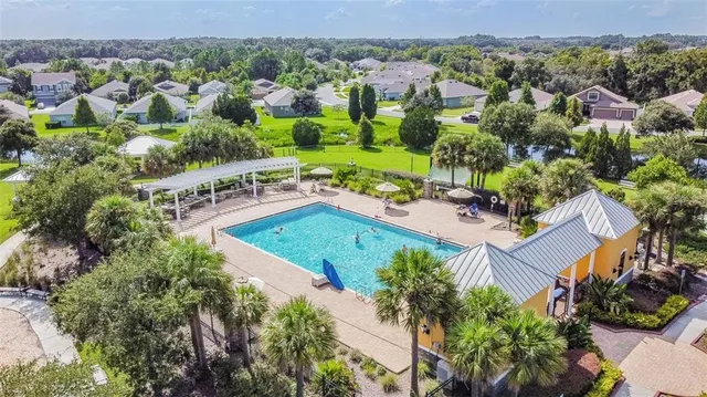 an aerial view of residential houses with outdoor space and parking