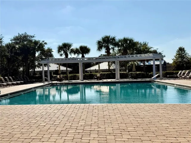 a view of swimming pool with outdoor seating