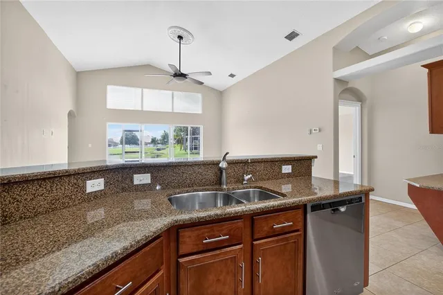 a kitchen with granite countertop a sink and a window