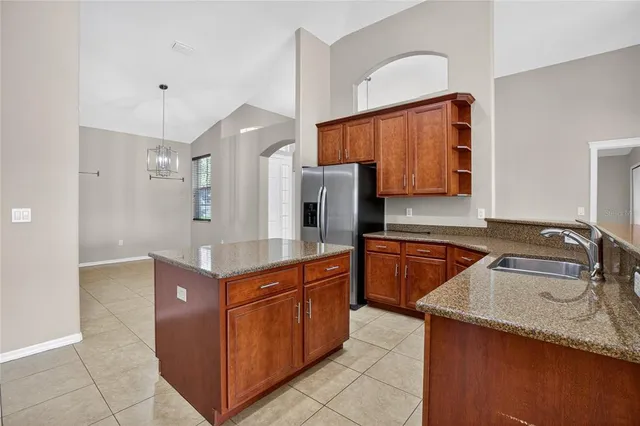 a kitchen with stainless steel appliances granite countertop a sink counter space and stove