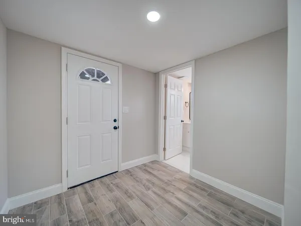 a view of an empty room and wooden floor