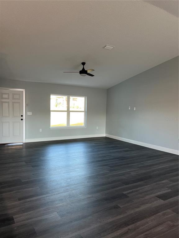 55 Northwest 45th Loop Ocala, FL 34475 - Photo 12 of 20 an empty room with wooden floor and windows