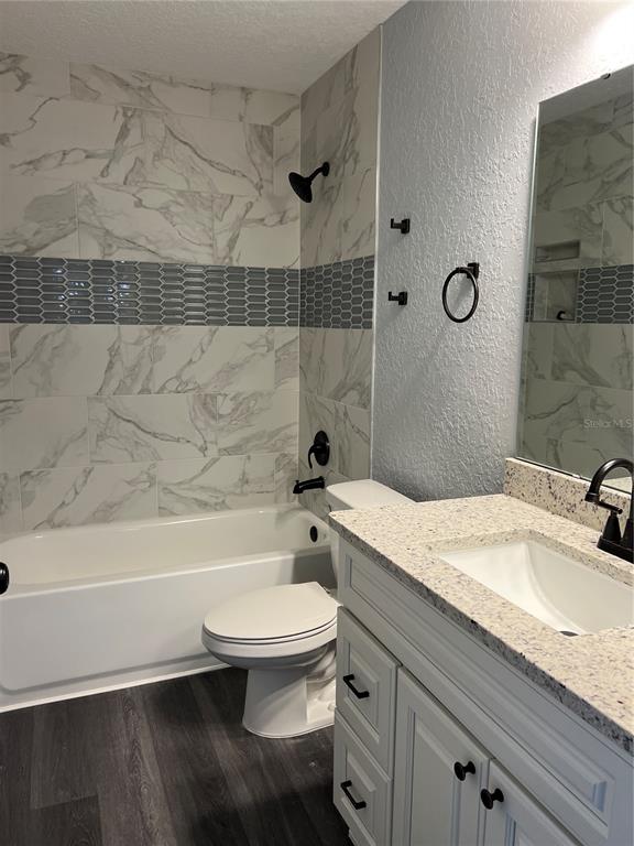 55 Northwest 45th Loop Ocala, FL 34475 - Photo 14 of 20 a bathroom with a granite countertop sink toilet a mirror and bathtub