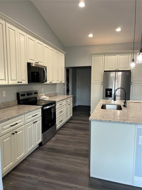 55 Northwest 45th Loop Ocala, FL 34475 - Photo 3 of 20 a kitchen with stainless steel appliances granite countertop a sink and cabinets