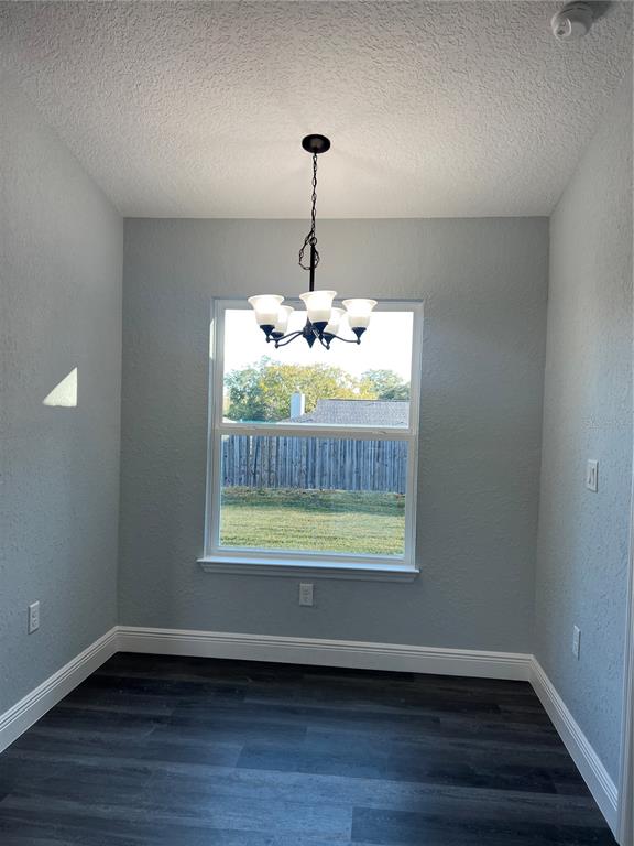 55 Northwest 45th Loop Ocala, FL 34475 - Photo 5 of 20 a view of an empty room with wooden floor and a window