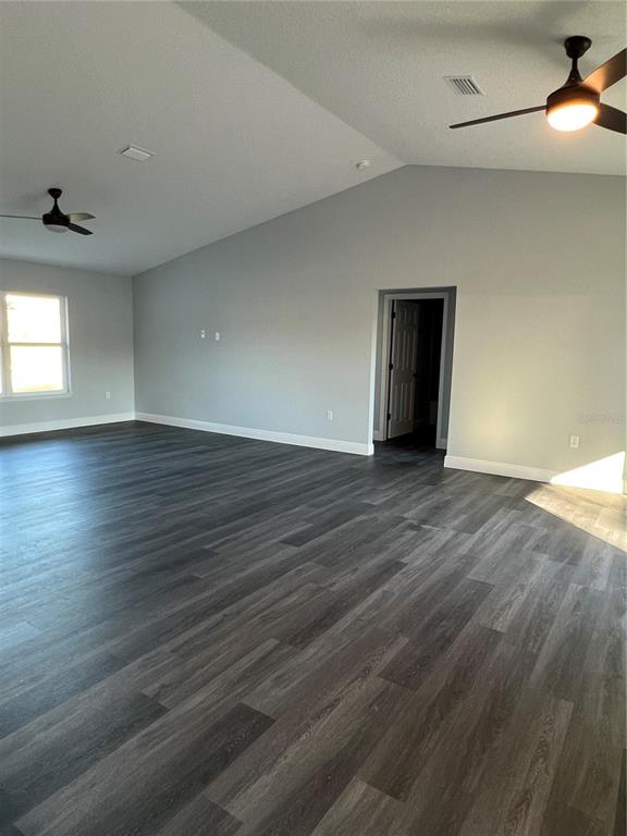 55 Northwest 45th Loop Ocala, FL 34475 - Photo 7 of 20 an empty room with wooden floor and windows