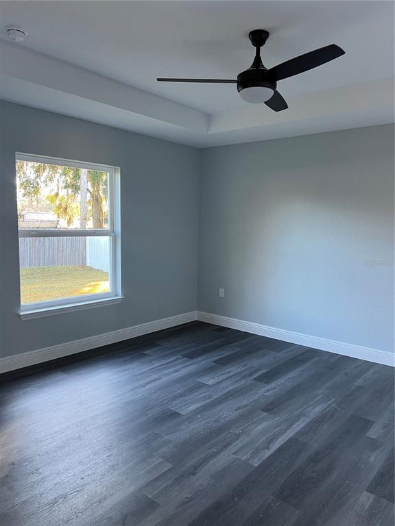 55 Northwest 45th Loop Ocala, FL 34475 - Photo 8 of 20 a view of an empty room with wooden floor and a window