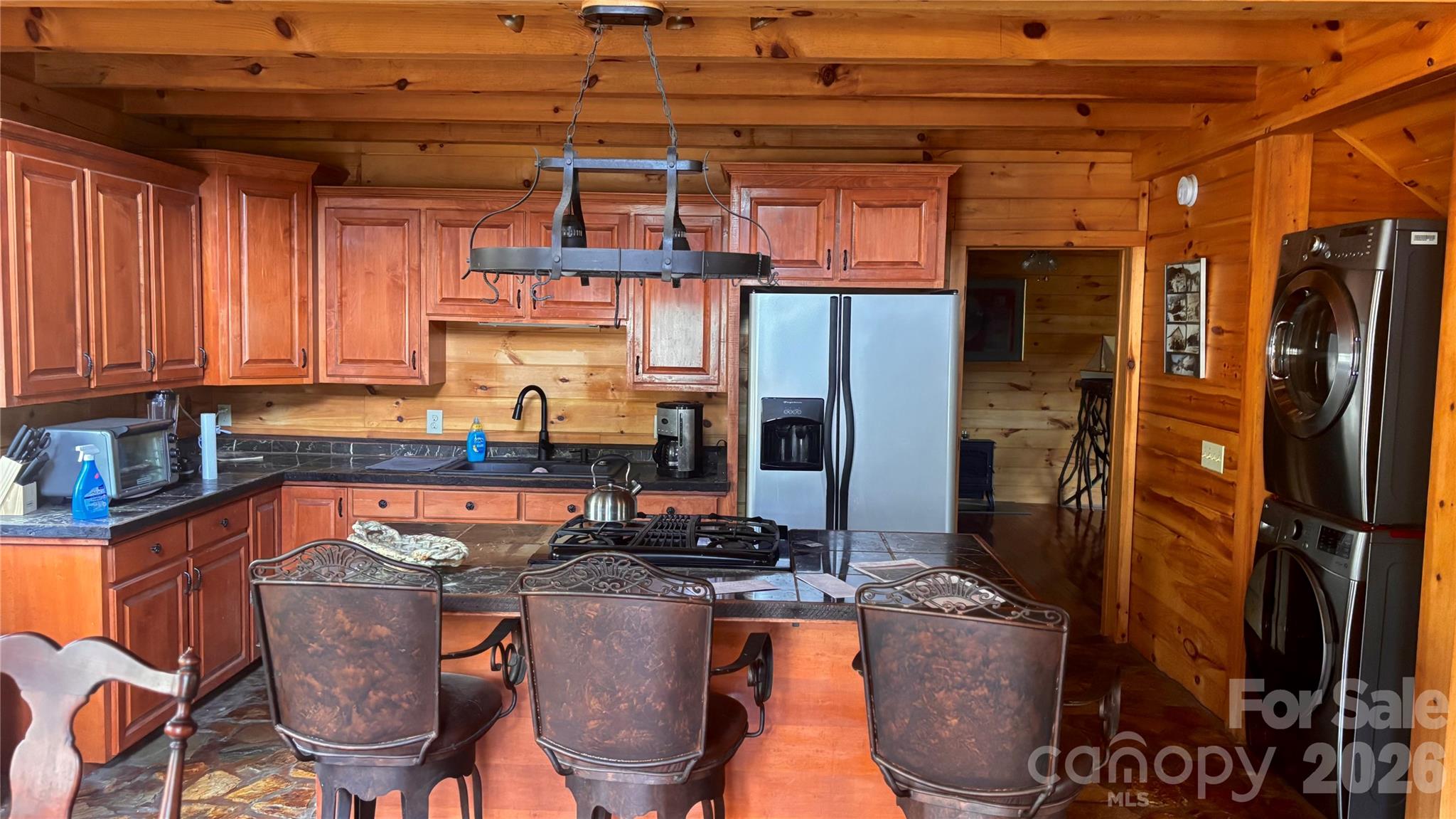 1694 Humpback Mountain Road Spruce Pine, NC 28777 - Photo 2 of 9 a room with stainless steel appliances granite countertop a refrigerator and a stove top oven