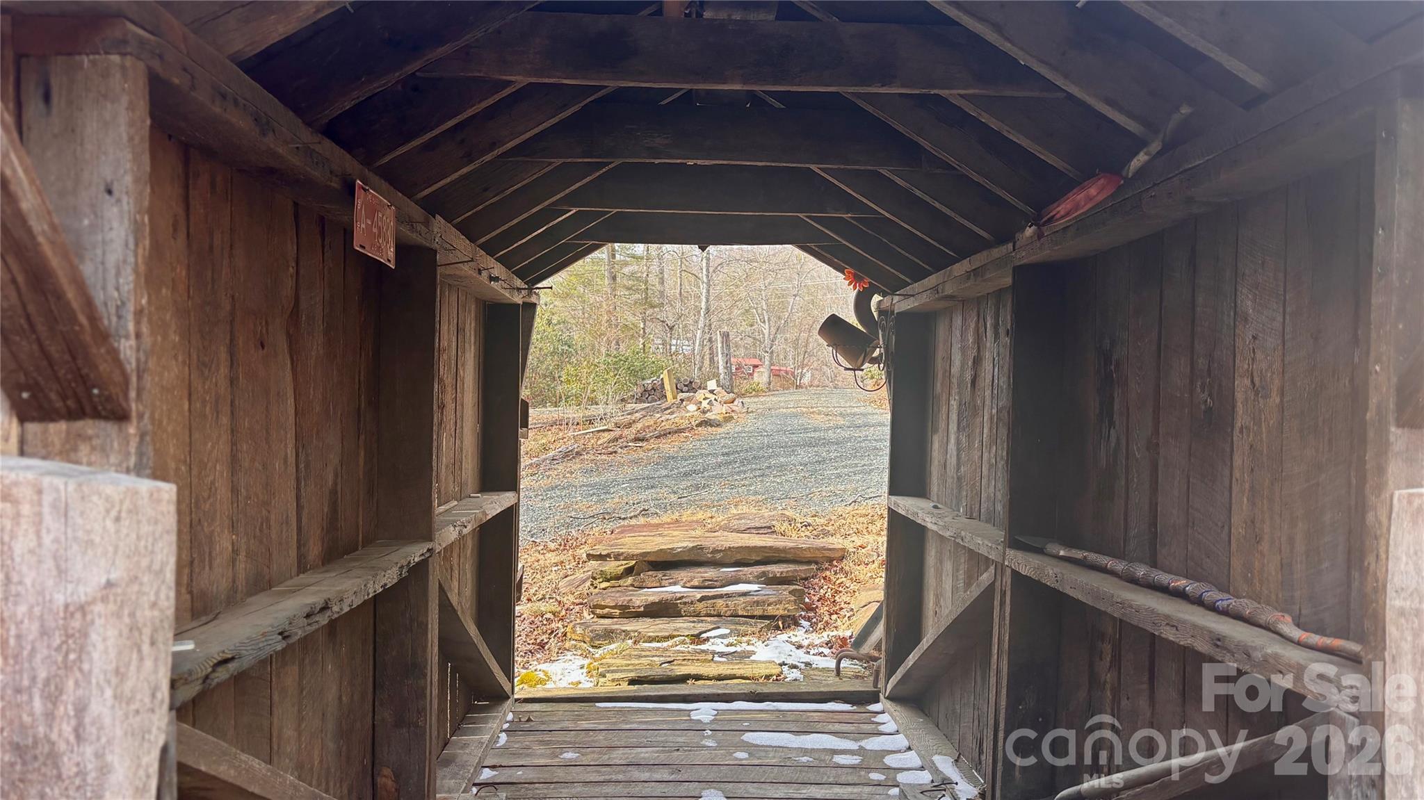 1694 Humpback Mountain Road Spruce Pine, NC 28777 - Photo 8 of 9 a view of empty room with wooden floor and fan
