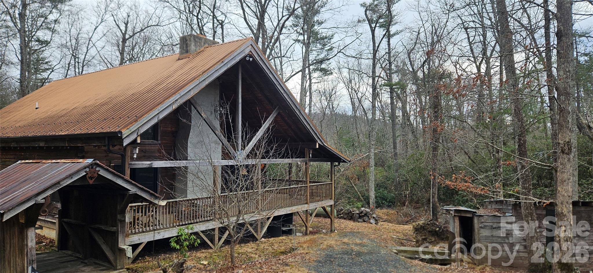 1694 Humpback Mountain Road Spruce Pine, NC 28777 - Photo 9 of 9 a house with trees in front of it