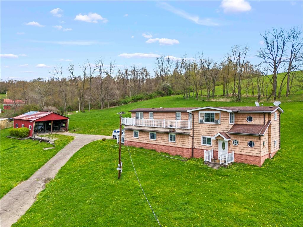 664 Banetown Road Washington, PA 15301 - Photo 3 of 27 a view of a big yard with table and chairs under an umbrella