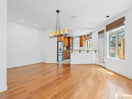 a view of a kitchen with a refrigerator and a window