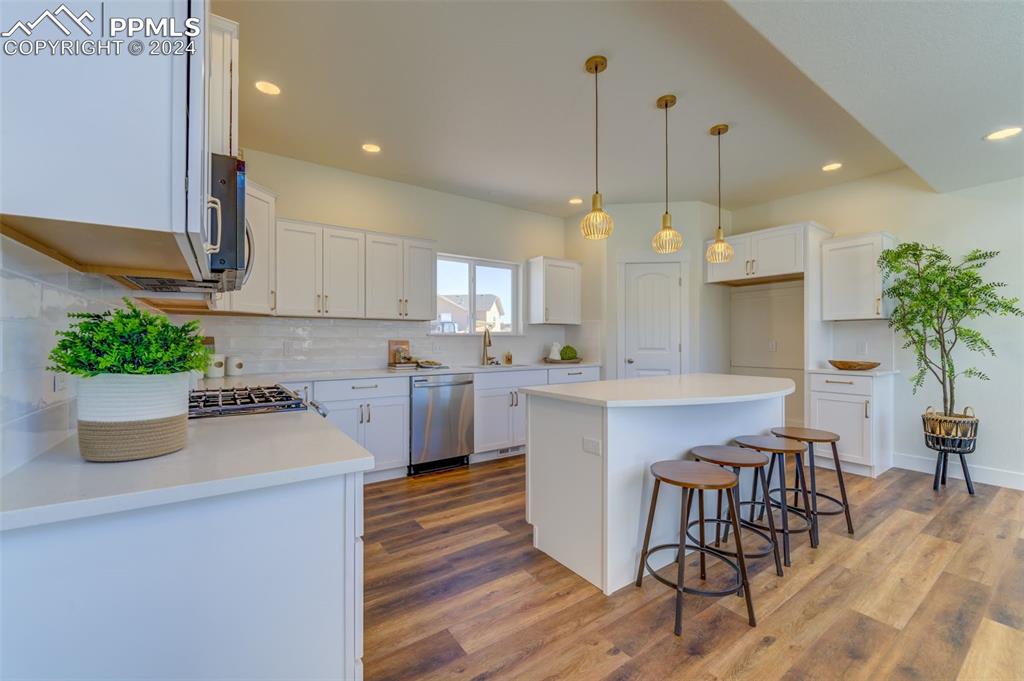 430 Miners Road Canon City, CO 81212 - Photo 13 of 50 a kitchen with a white cabinets and chairs