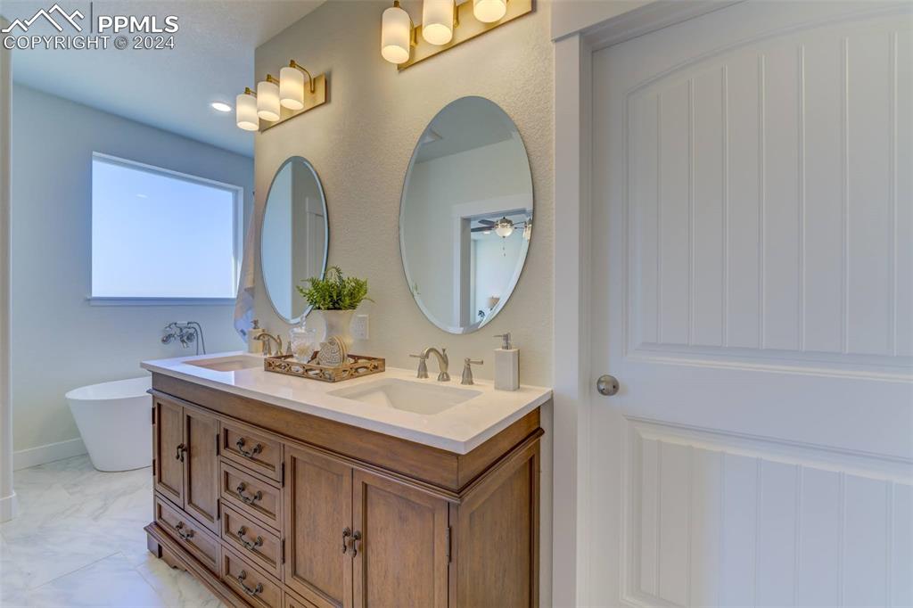 430 Miners Road Canon City, CO 81212 - Photo 23 of 50 a bathroom with a double vanity sink and a mirror