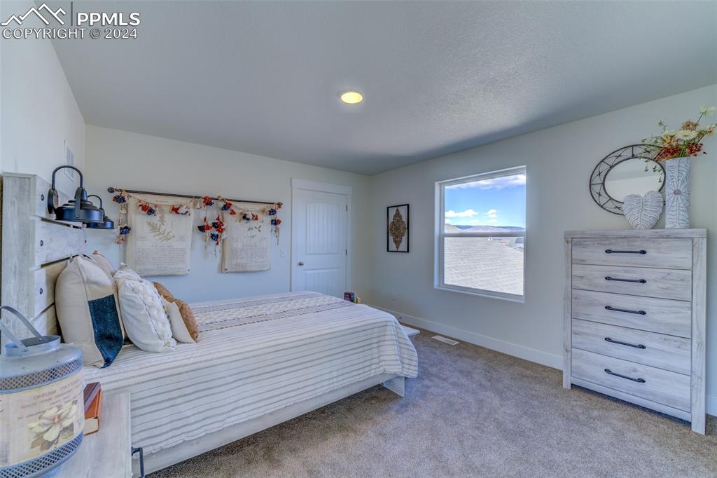 430 Miners Road Canon City, CO 81212 - Photo 36 of 50 a bedroom with a bed and a window
