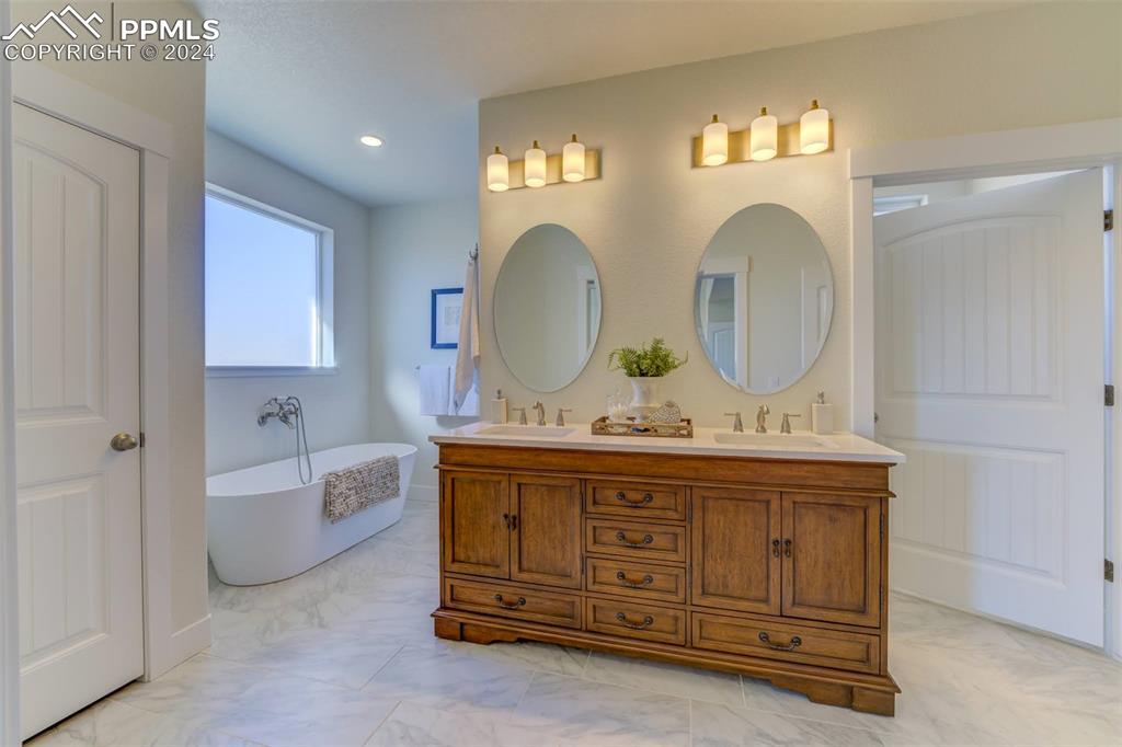 430 Miners Road Canon City, CO 81212 - Photo 4 of 50 a bathroom with a granite countertop sink a mirror and a bathtub
