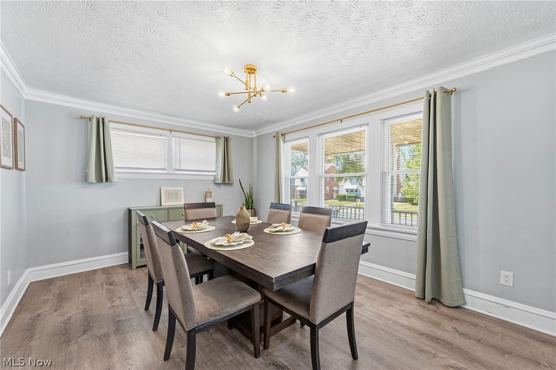 3386 Sylvanhurst Road Cleveland Heights, OH 44112 - Photo 3 of 46 Spacious room featuring wood-finish flooring, light grey walls, and white crown molding