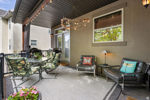 882 Sego Lily Way Mapleton, UT 84664 - Photo 31 of 41 Covered patio featuring an outdoor area rug, overhead string lighting, a garden door, and a single window