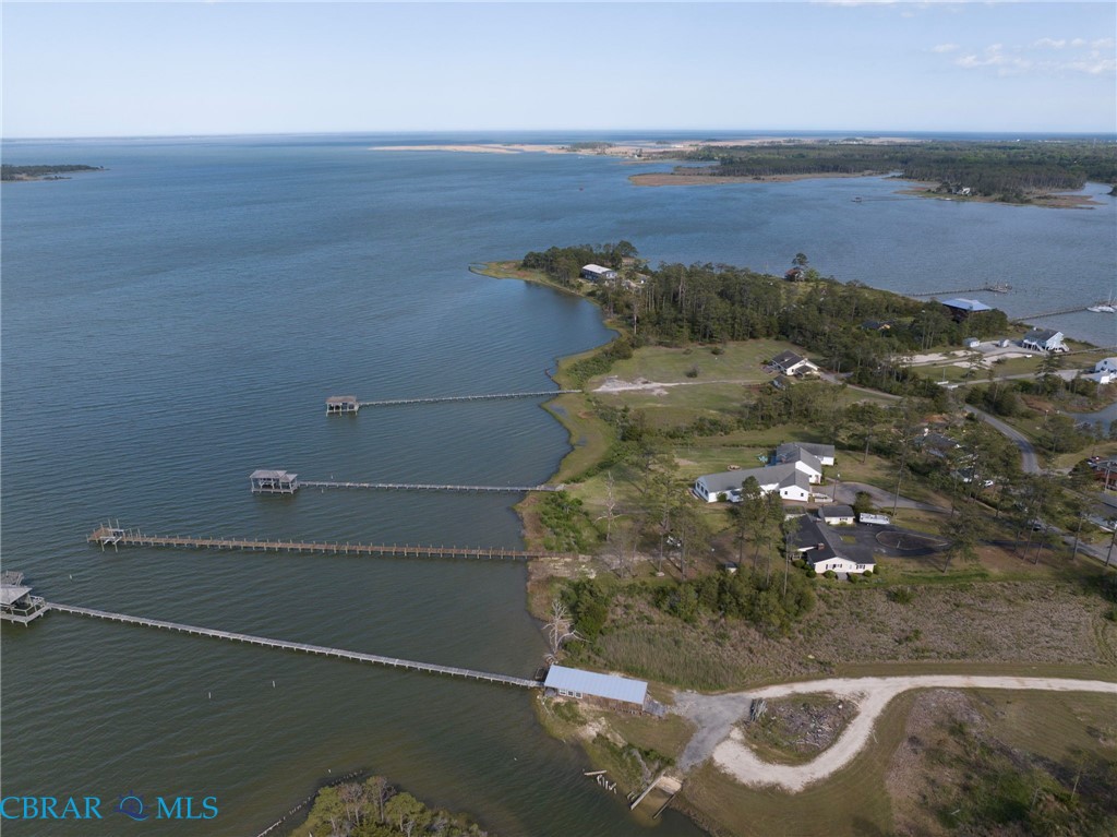 9093 Stump Point Road Hayes, VA 23072 - Photo 38 of 40 Expansive waterfront property featuring multiple private docks with covered boat lifts, direct water access, and a varied landscape of mature trees and cleared areas