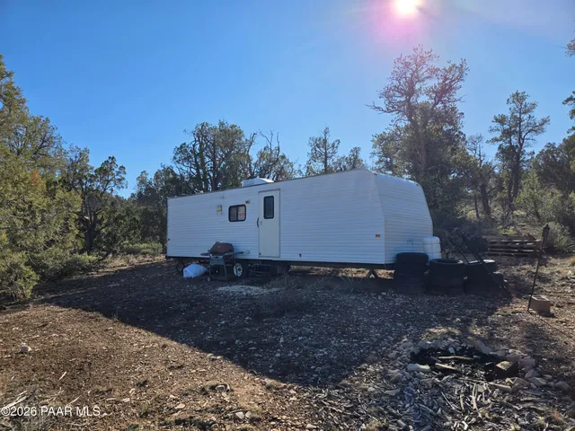 a view of a barn in the middle of a yard