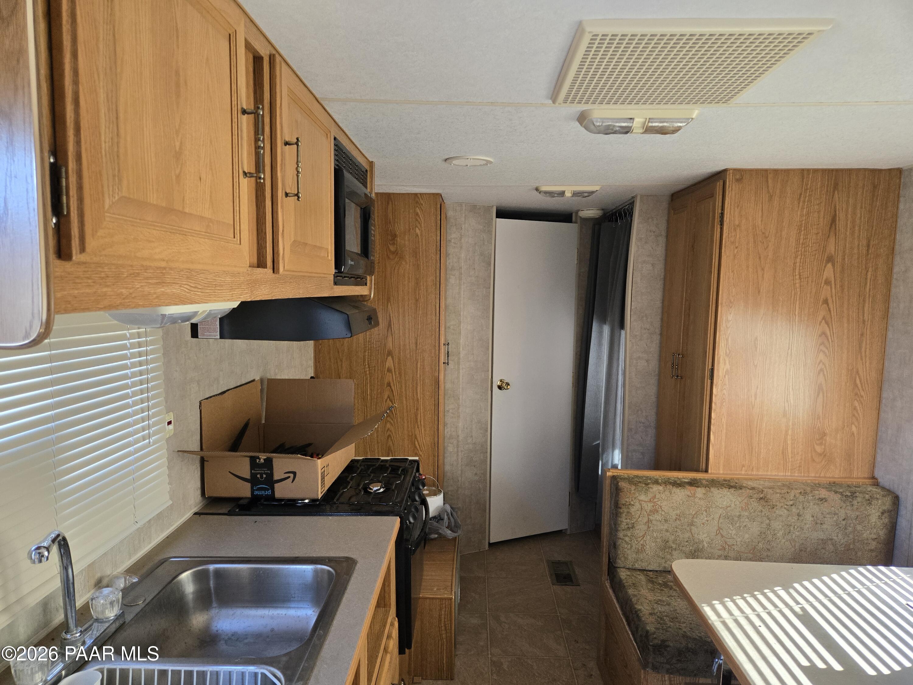 138 Arizona Road Ash Fork, AZ 86320 - Photo 13 of 21 a kitchen with a sink and a refrigerator