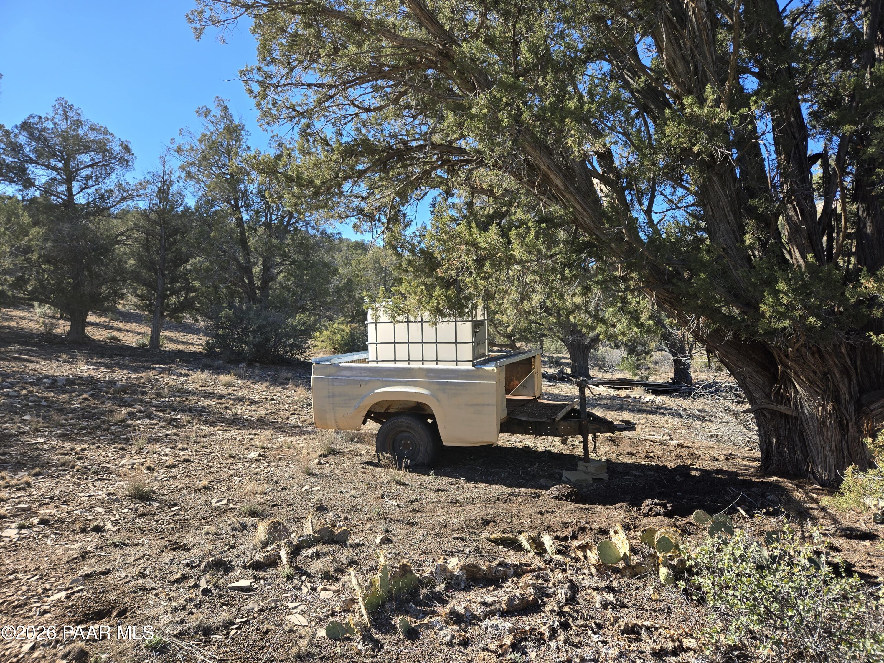 138 Arizona Road Ash Fork, AZ 86320 - Photo 4 of 21 a view of a backyard with table and chairs and a fire pit