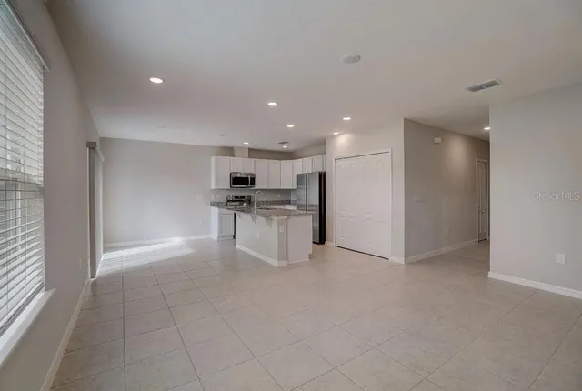 a kitchen with kitchen island a counter top space stainless steel appliances and cabinets