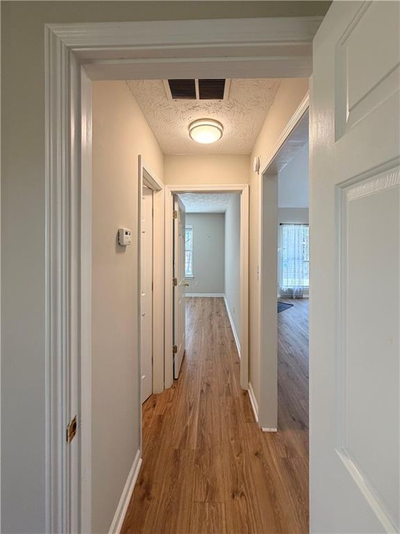 2575 Hamilton Parc Lane Northeast Buford, GA 30519 - Photo 24 of 63 a view of a hallway with wooden floor and a glass door