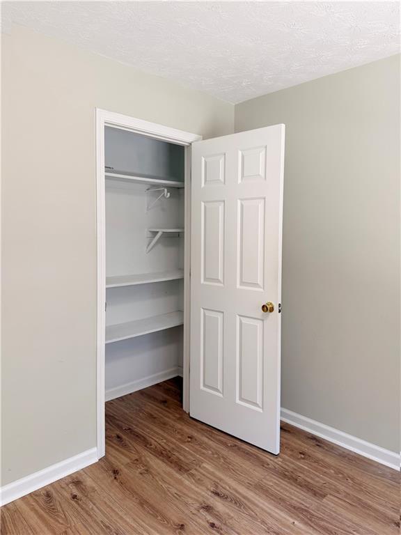 2575 Hamilton Parc Lane Northeast Buford, GA 30519 - Photo 28 of 63 a view of an empty room with wooden floor