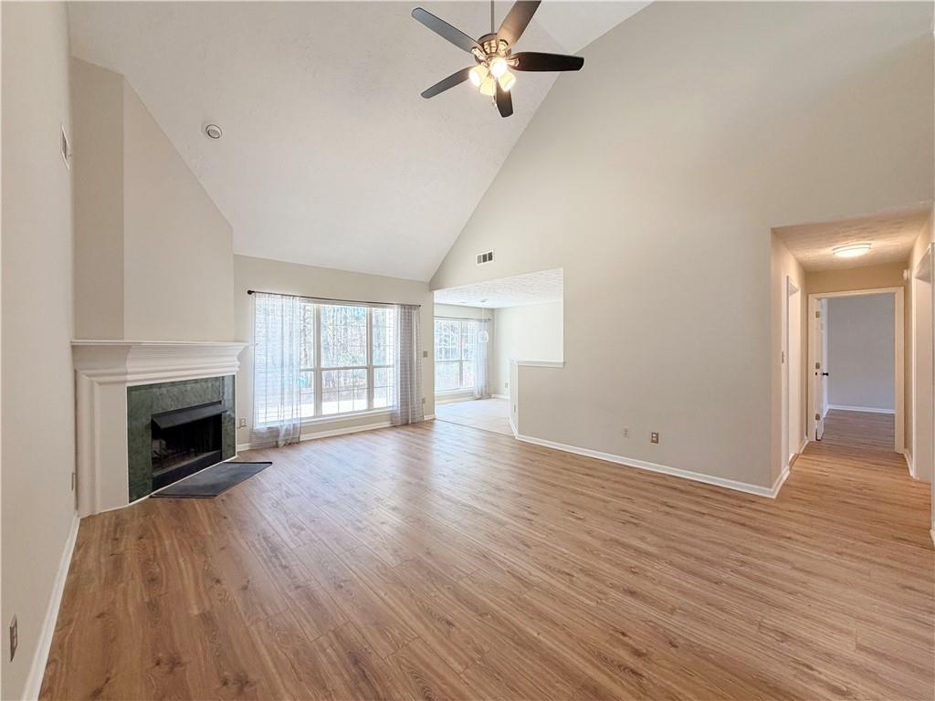 2575 Hamilton Parc Lane Northeast Buford, GA 30519 - Photo 35 of 63 wooden floor fireplace and natural light in room