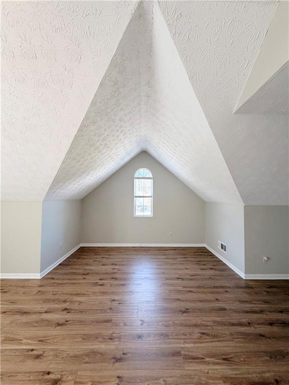 2575 Hamilton Parc Lane Northeast Buford, GA 30519 - Photo 54 of 63 a view of an empty room and wooden floor