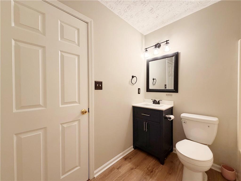 2575 Hamilton Parc Lane Northeast Buford, GA 30519 - Photo 59 of 63 a bathroom with a toilet a sink and mirror