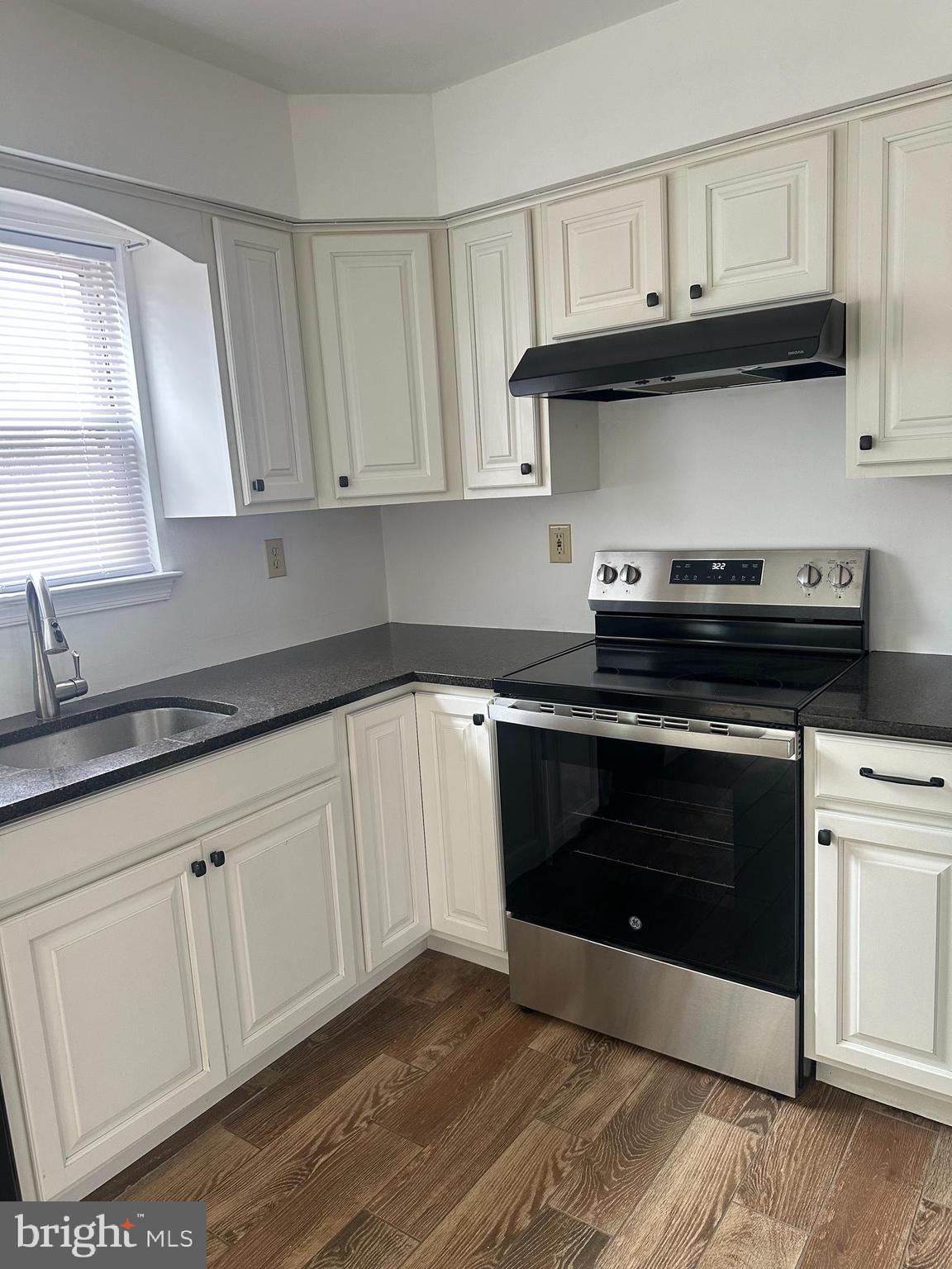 2073 Clover Mill Road Quakertown, PA 18951 - Photo 4 of 17 a kitchen with granite countertop white cabinets and a stove
