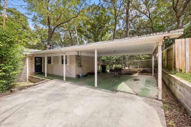 a view of a house with a backyard porch and sitting area