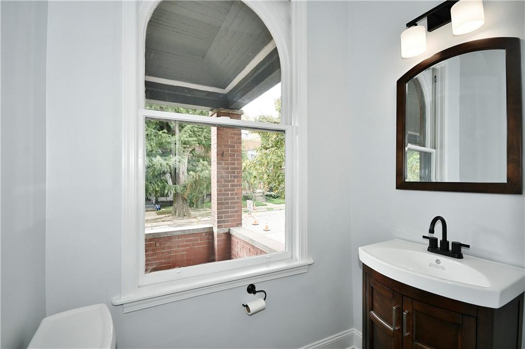6029 Stanton Avenue Pittsburgh, PA 15206 - Photo 12 of 27 a bathroom with a sink mirror and a window