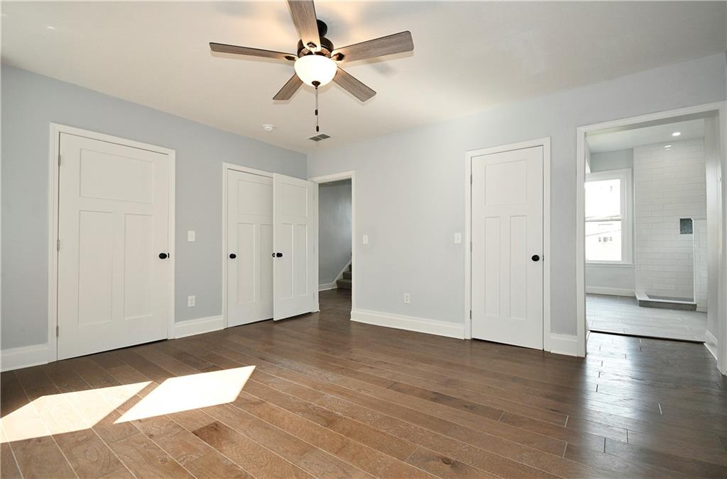 6029 Stanton Avenue Pittsburgh, PA 15206 - Photo 14 of 27 an empty room with wooden floor and ceiling fan