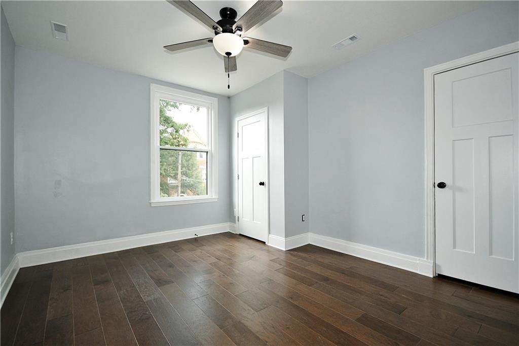 6029 Stanton Avenue Pittsburgh, PA 15206 - Photo 18 of 27 a view of an empty room with wooden floor and a window