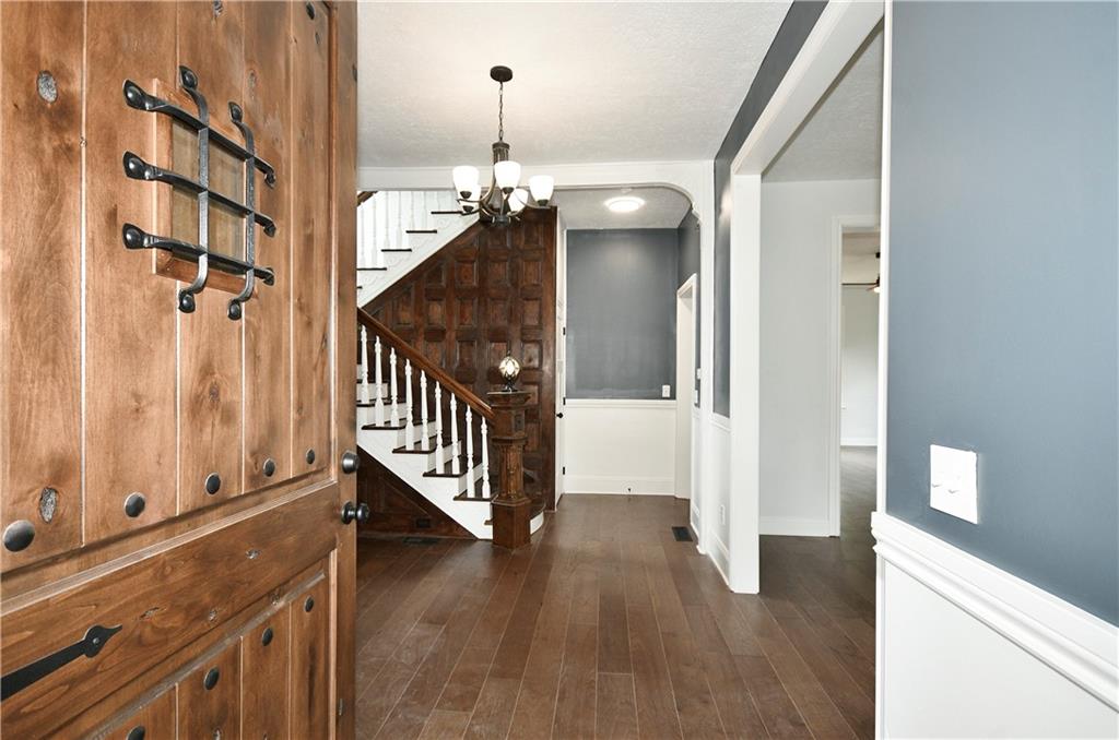6029 Stanton Avenue Pittsburgh, PA 15206 - Photo 2 of 27 a view of a hallway with wooden floor and staircase