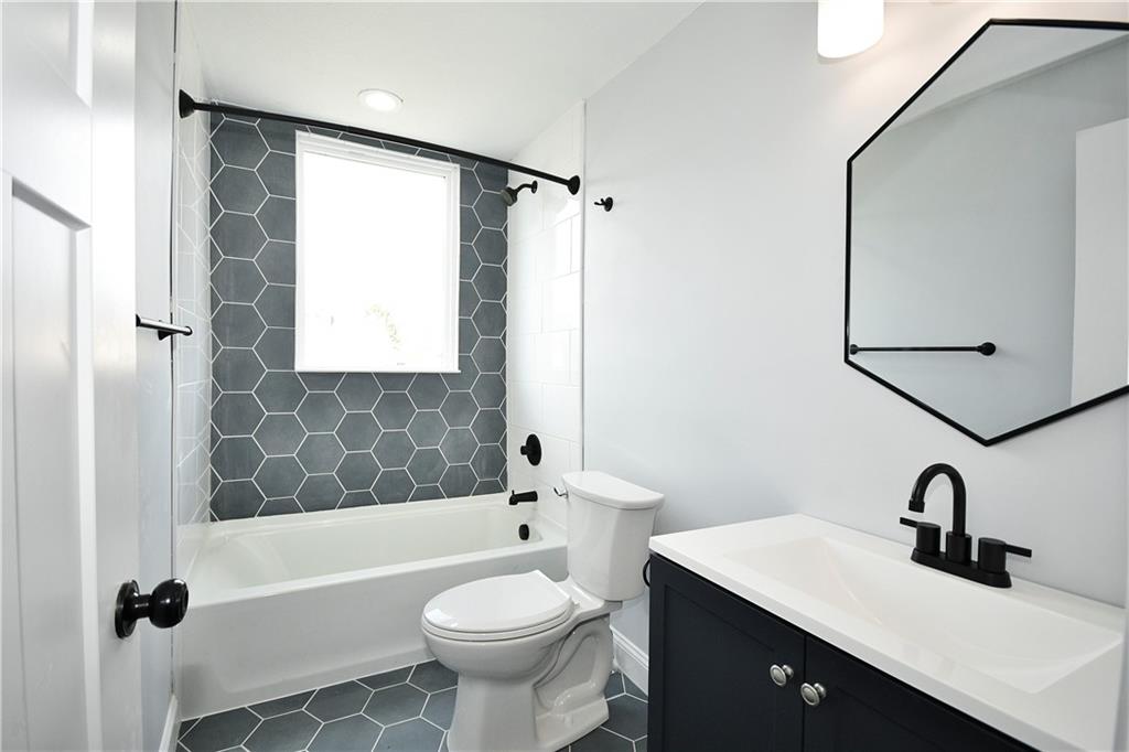 6029 Stanton Avenue Pittsburgh, PA 15206 - Photo 24 of 27 a bathroom with a sink toilet a mirror and shower