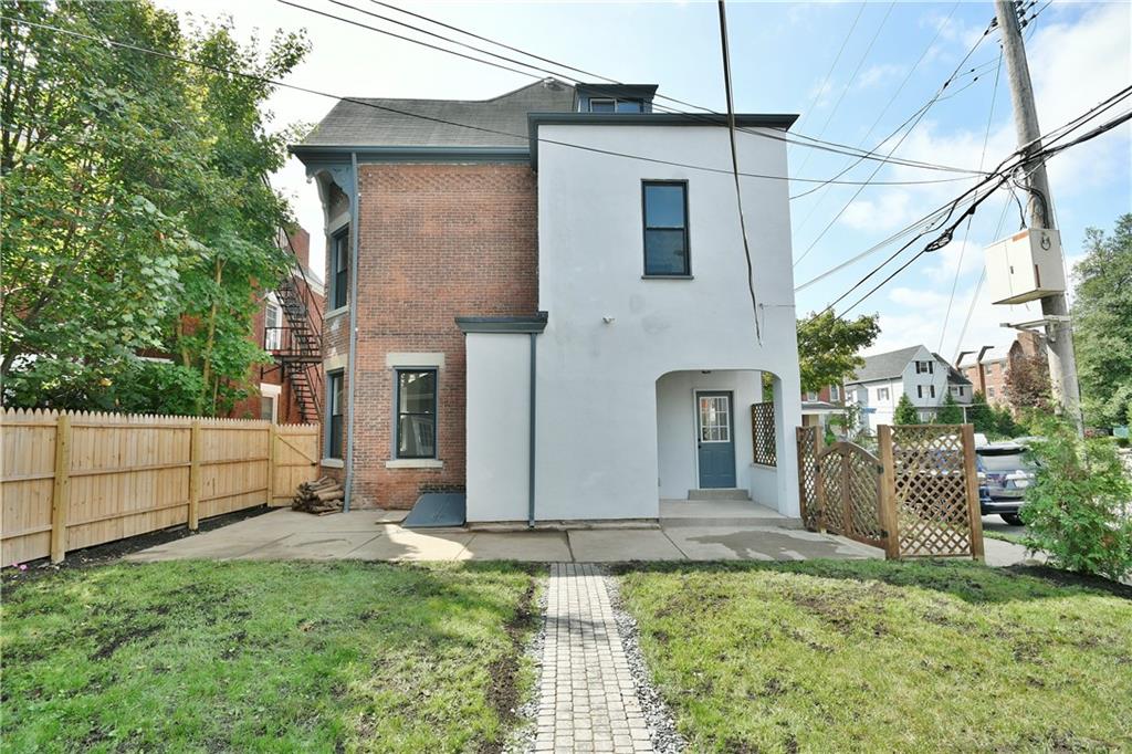 6029 Stanton Avenue Pittsburgh, PA 15206 - Photo 26 of 27 a front view of a house with a yard