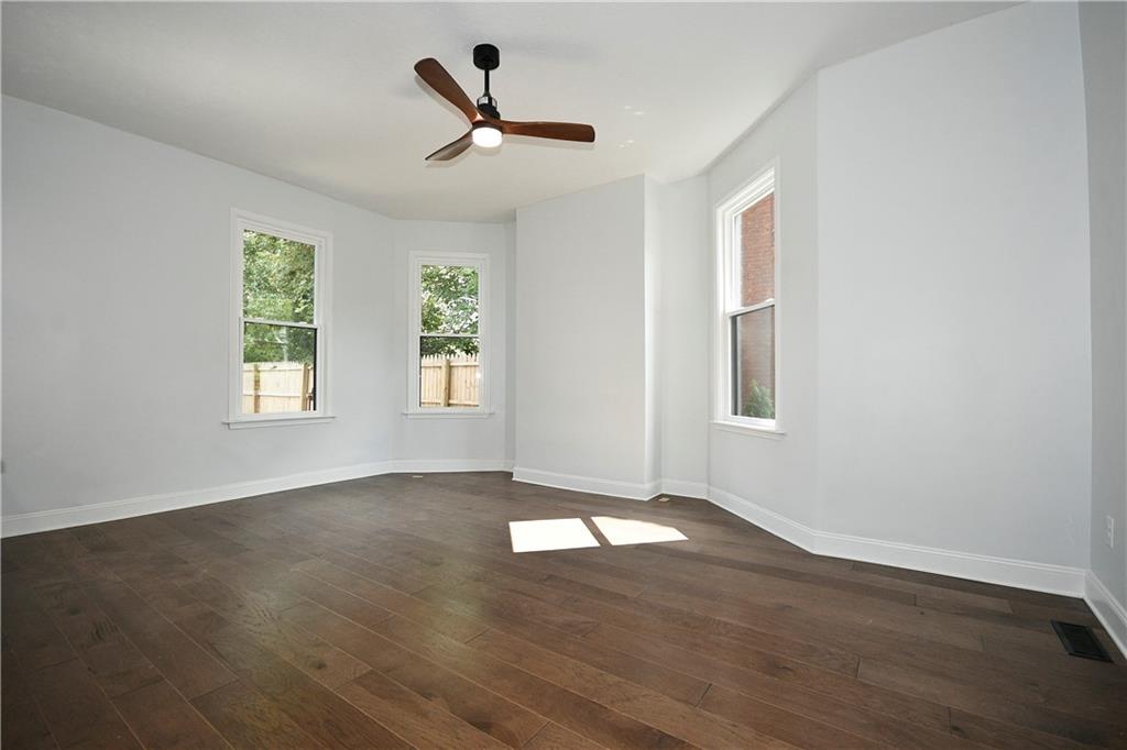 6029 Stanton Avenue Pittsburgh, PA 15206 - Photo 7 of 27 a view of a big room with wooden floor and windows