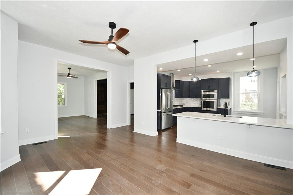 6029 Stanton Avenue Pittsburgh, PA 15206 - Photo 8 of 27 a view of a kitchen with wooden floor and a window